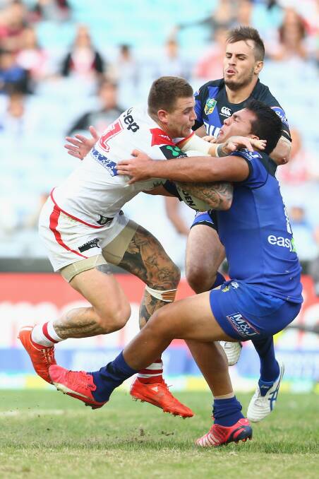 Dragons fullback Josh Dugan is tackled by Josh Reynolds and Lloyd Perrett of the Bulldogs. Picture: GETTY IMAGES