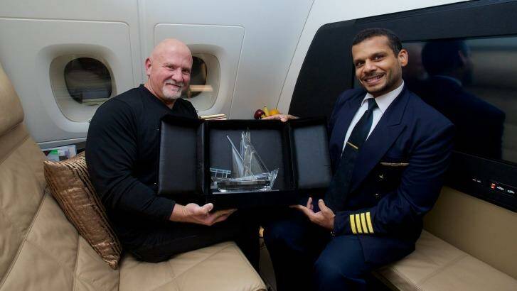 Gino Bertuccio, in the Residence living room, receives a commemorative crystal dow from Captain Ali Al Jabri, who took control of Etihad Airways inaugural A380 flight.
