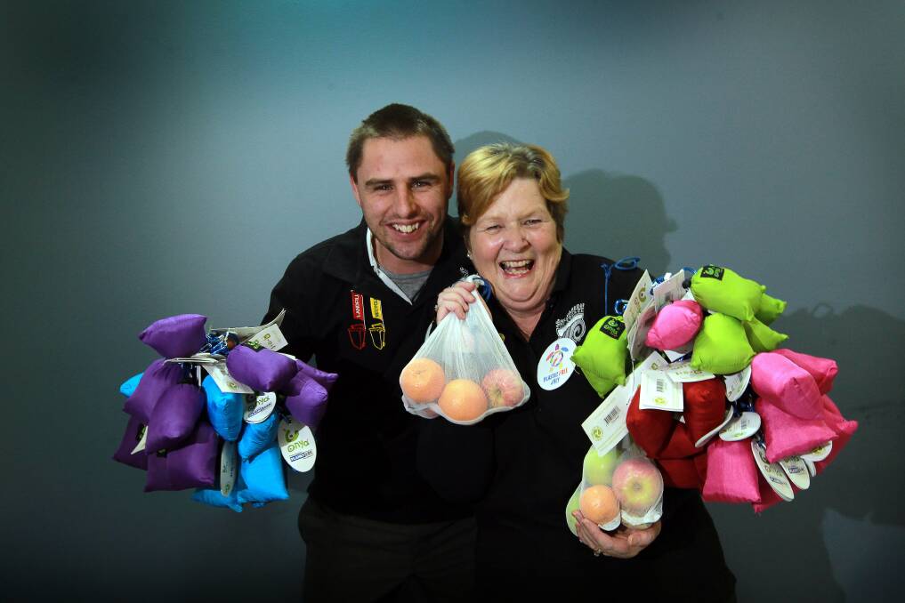 Council staff Rylan Loemker and Margaret Lawlor hold mesh bags. Picture: SYLVIA LIBER