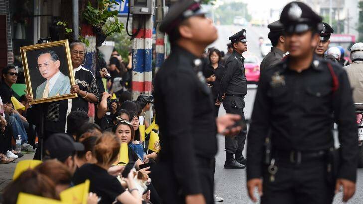 Police officers on duty dressed in black for King Bhumibol Adulyadej's death at the age of 88. Photo: Kate Geraghty