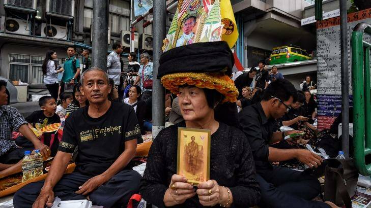 Crowds gather outside Siriraj Hospital in Bangkok on Friday following the king's death. Photo: Kate Geraghty
