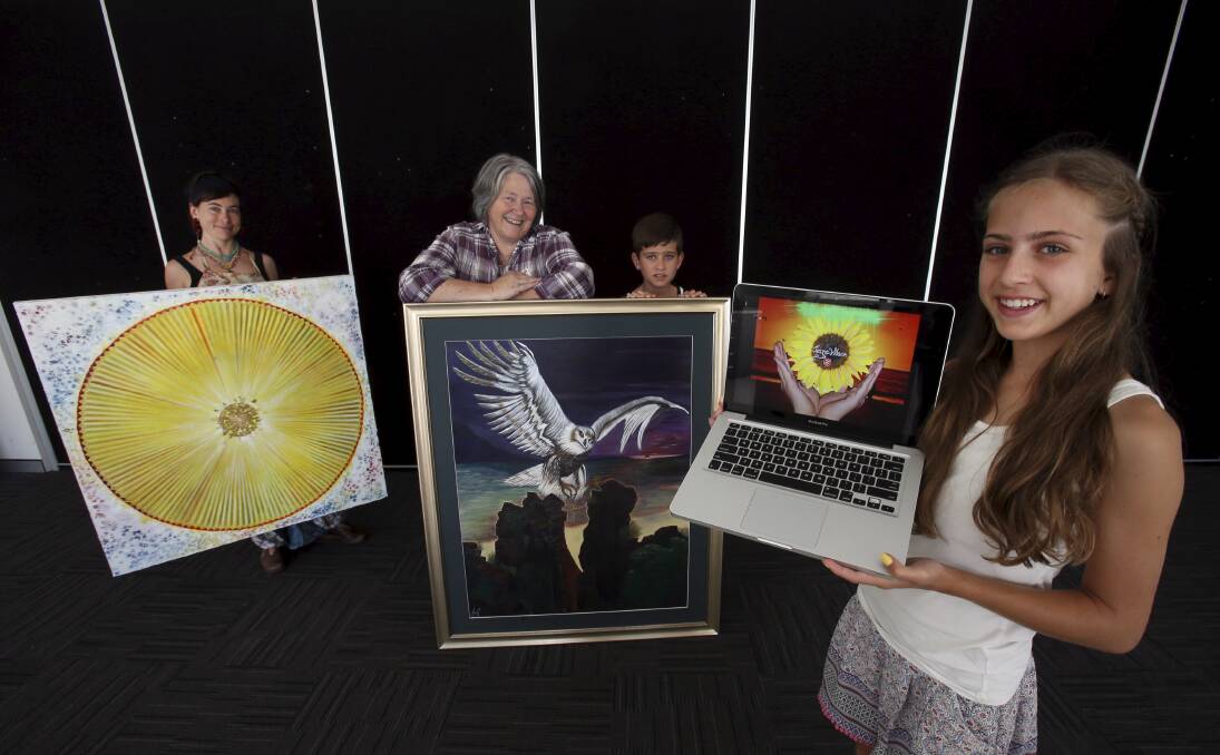 Artist Shining Rainbow (left), The Salvation Army’s   Marilyn Dunn and Jayne Wilson’s grandson Caleb Flemming, 11, with Jayne’s painting, and granddaughter Casey Flemming, 13, with her PowerPoint display. The Jayne Wilson Memorial Exhibition will run from January 23-February 1. Picture: KIRK GILMOUR