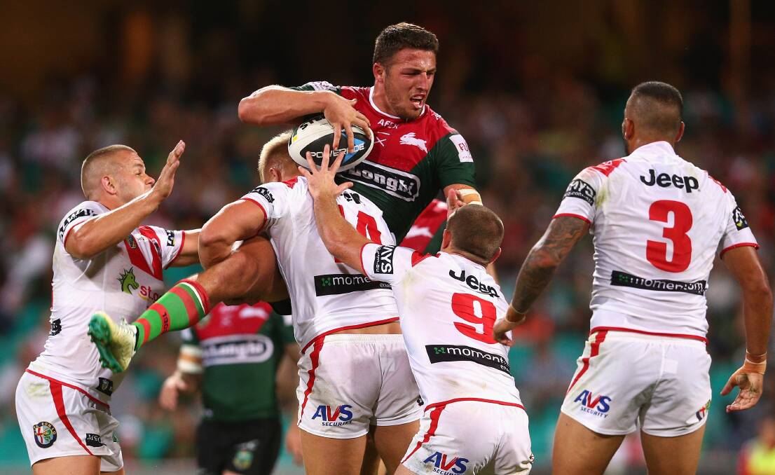 The Rabbitohs' Sam Burgess is lifted in a tackle by St George Illawarra's Jack de Belin last Saturday night. Picture: GETTY IMAGES