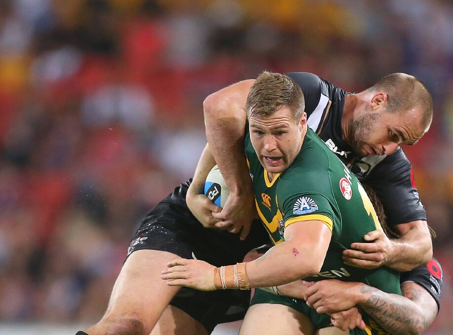 Australia's Trent Merrin is tackled by New Zealand's during the trans-Tasman Test match in Brisbane on Sunday, won 26-12 by the Kiwis. Picture: GETTY IMAGES