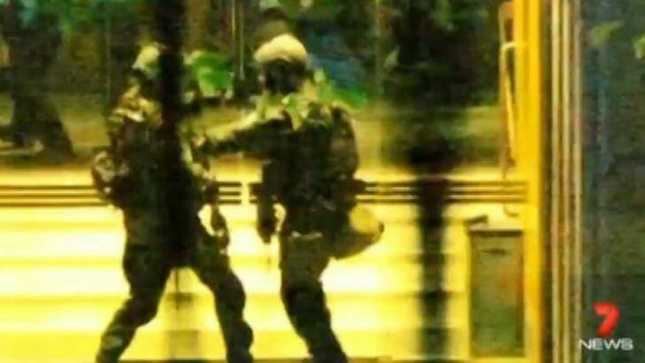 Police towards the siege's end: Parker had three cameras trained on the cafe. Photo: Channel Seven