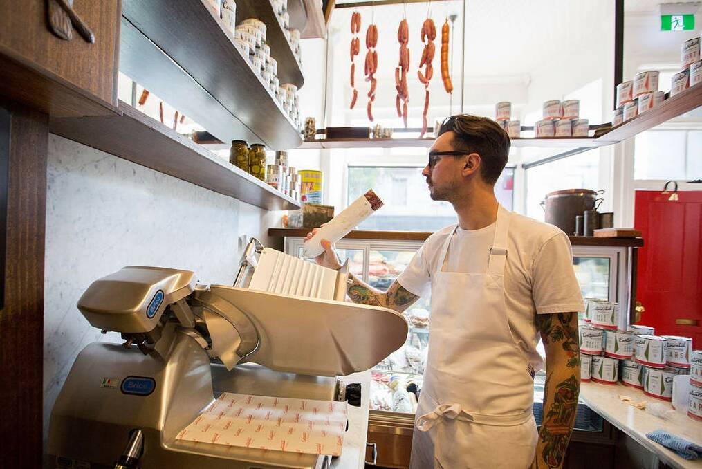 Chef Jesse Warkentin on the meat slicer. Photo: Michele Mossop