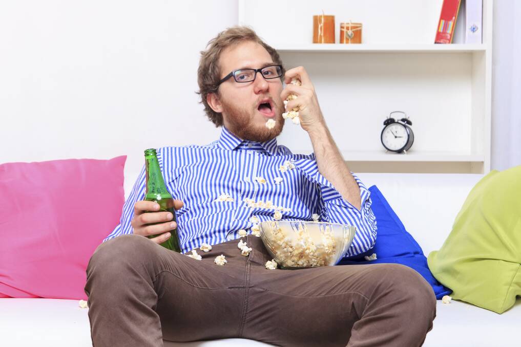 Mindlessly eating in front of the TV can be hazardous to your diet and in turn your health and wellbeing. Picture: iSTOCK IMAGES