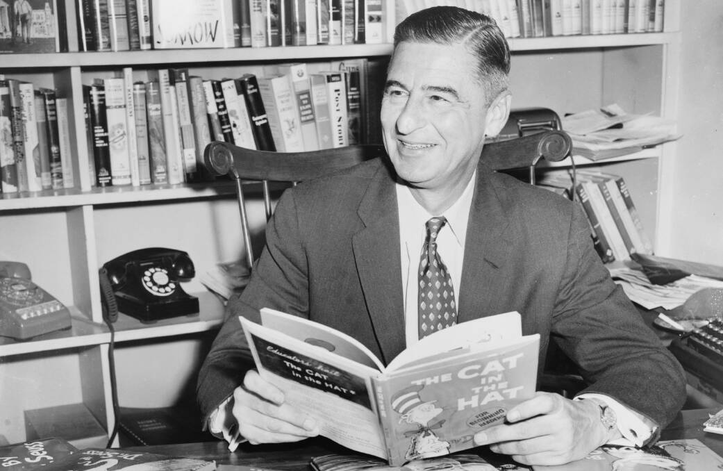 Children's author and cartoonist Theodor Seuss Geisel, who died in 1991, hold his most popular book The Cat in the Hat.