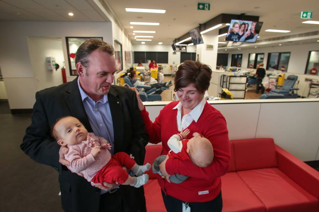 Blood donor Leigh Stewart at the Wollongong blood bank with nurse Susan Moreno and his nephew and niece, Victoria and Walter Stewart. Picture: ADAM McLEAN