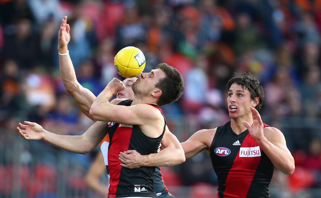 Essendon's Jackson Merrett attempts a no-look hand pass in the 32-point loss to GWS. Picture: GETTY IMAGES