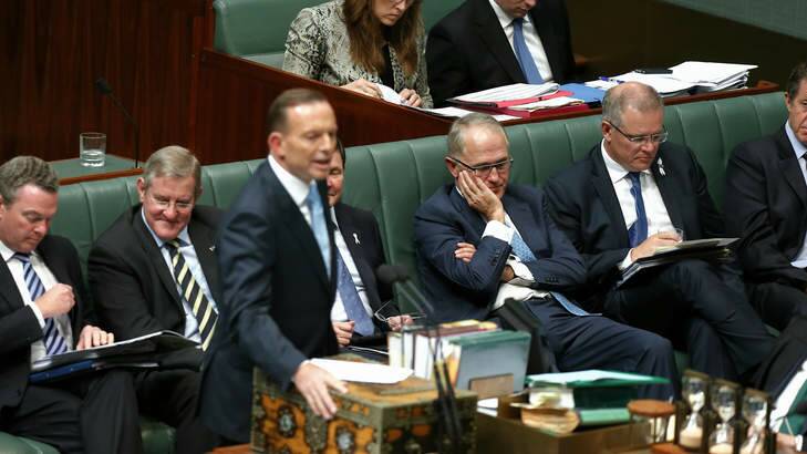 Communications Minister Malcolm Turnbull listens as Prime Minister Tony Abbott answers a question on ABC funding during Question Time on Monday. Photo: Alex Ellinghausen