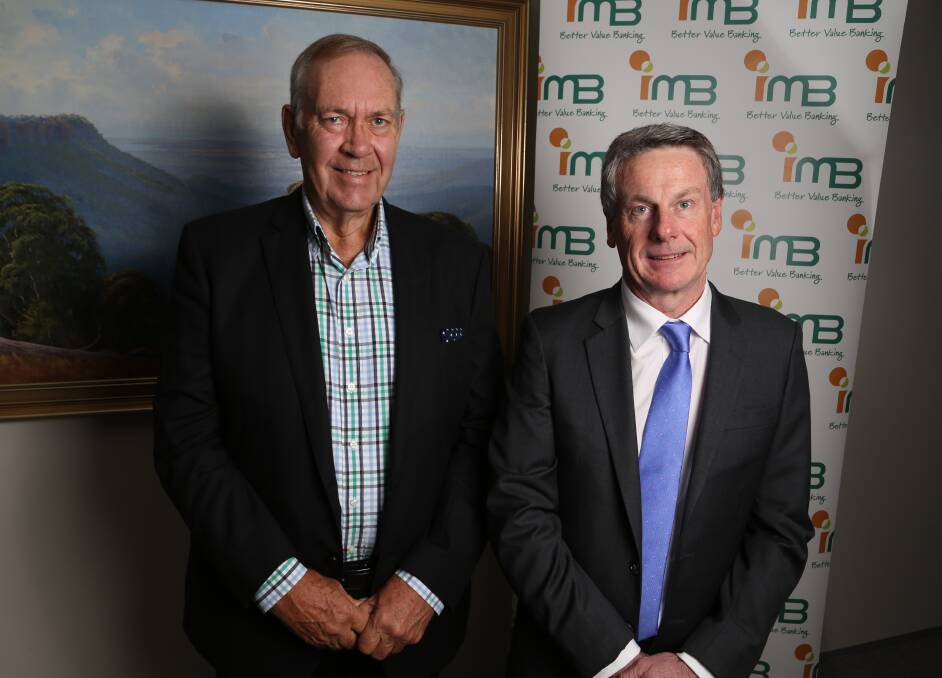 Successful move: Doug Symes and Robert Ryan discuss the IMB's third successful share buyback. Picture: GREG ELLIS