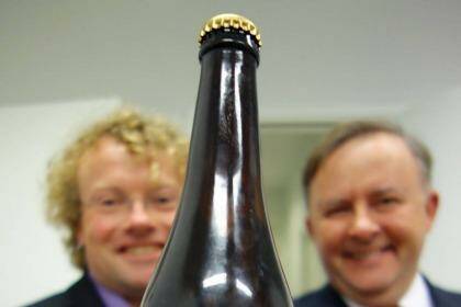 Anthony Albanese holding a bottle of the beer that was named after him.