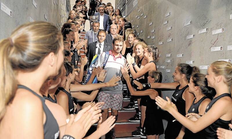 Switzerland's Stan Wawrinka is feted entering the locker room after his surprise French Open final win in four sets. Picture: REUTERS