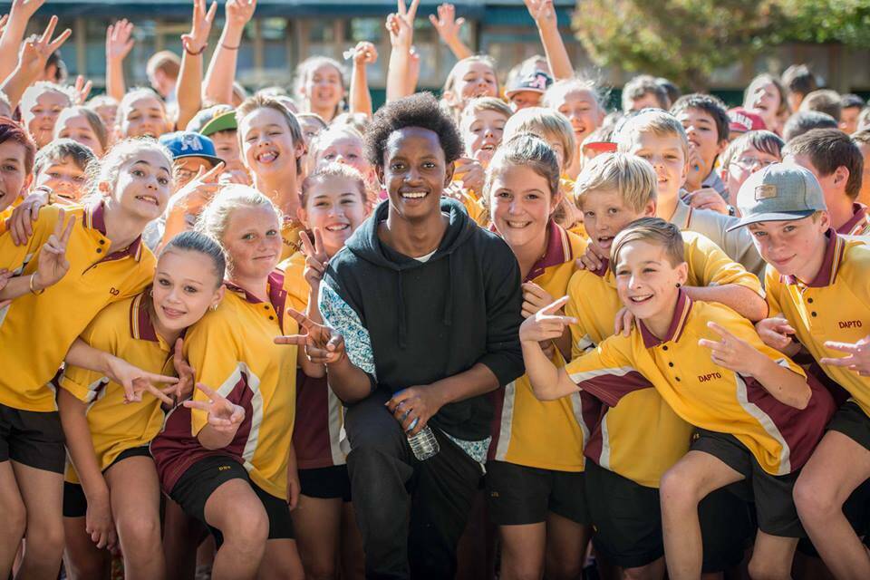 Sadoc N Bizzy with Dapto High School year 7 students during Refugee Week activities.