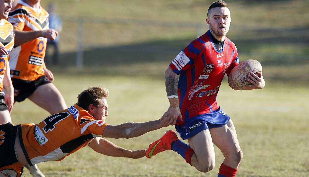 Wests' Josh Goulton slips past Helensburgh defenders at Rex Jackson Oval. Picture: SYLVIA LIBER