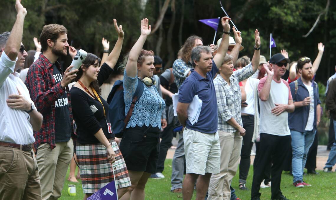 Hands up: Students show their support at the Call for Action rally at University of Wollongong against the reform bill. Picture: KIRK GILMOUR