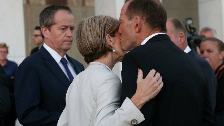 Unity: Bill Shorten looks on as Tony Abbott kisses Julie Bishop. Photo: Alex Ellinghausen
