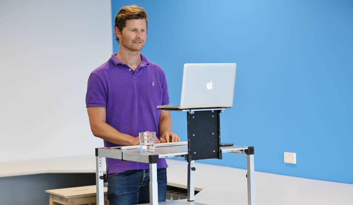 James Moore with the first prototype of his standing desk, which he will launch in May.Picture: GREG ELLIS
