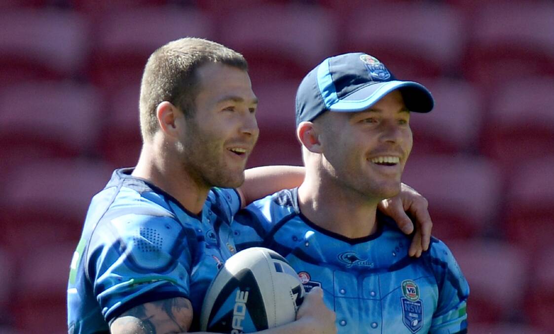 Newcastle's Beau Scott (right), sharing a laugh with NSW teammate Trent Merrin, has a close bond with departing club coach Wayne Bennett. Picture: GETTY IMAGES