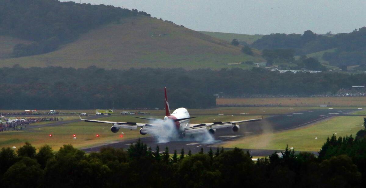 Touchdown: The Qantas 747 touches down at Illawarra Regional Airport on Sunday. Picture: KIRK GILMOUR