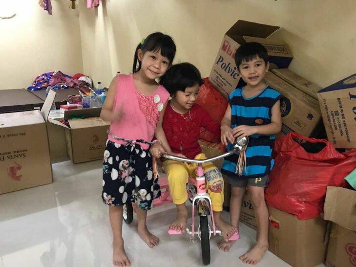 The three youngest children play with a tricycle donated by members of the Jakarta Vietnamese community inside their cell in the detention centre. They have not been allowed outside for the past two months. Undated Photo: Shira Sebban  Supplied