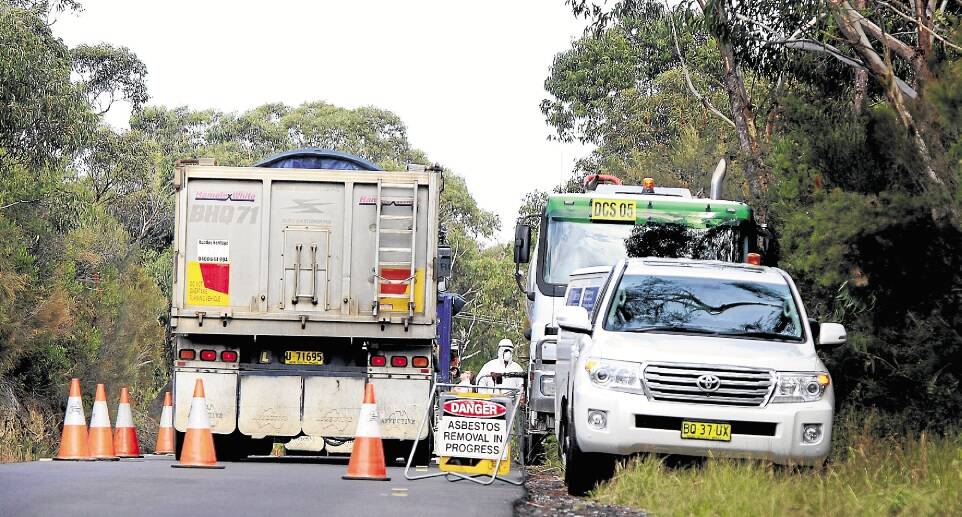 Bungle: Contractors at work on the Old Princes Highway remove the mounds of construction waste placed there by council in a bid to halt illegal dumping. Picture: SYLVIA LIBER