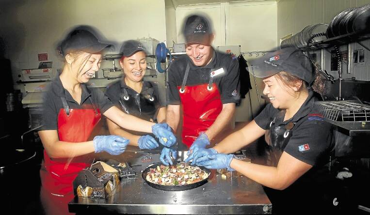 Qualifiers: Dapto Dominos Pizza makers Mandy Li, Amanda Chang, Joshua Bell and Natalie Chang practise techniques.Picture: SYLVIA LIBER