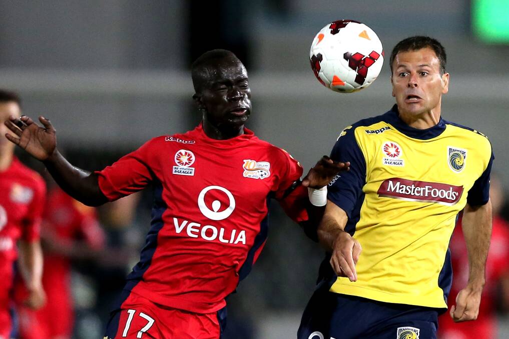 Rivalry: Awer Mabil of Adelaide United contests the ball against Mile Sterjovski of the Mariners during the teams' A-League elimination finals match at Central Coast Stadium last Saturday. Picture: GETTY IMAGES