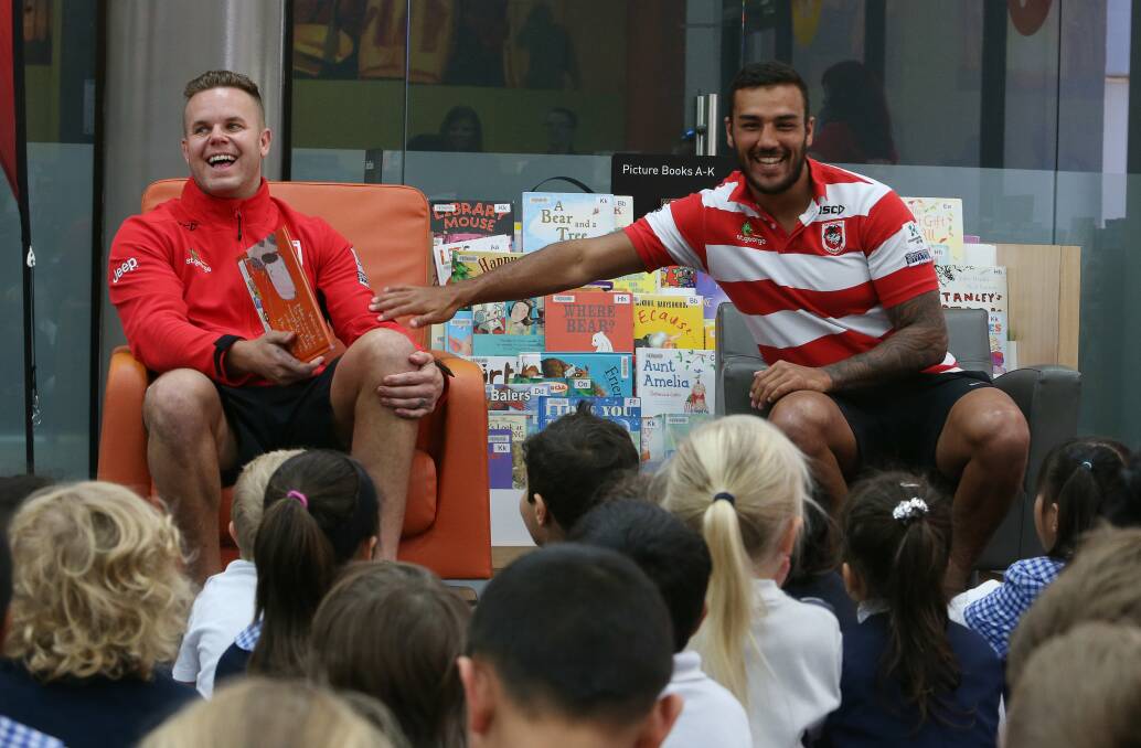 Fun: St George Illawarra Dragons players Dan Hunt and Dylan Farrell take time out from training to read books to 75 kindergarten students at Wollongong Library as part of the National Simultaneous Storytime, designed this year to show boys reading is "cool".Picture: ROBERT PEET