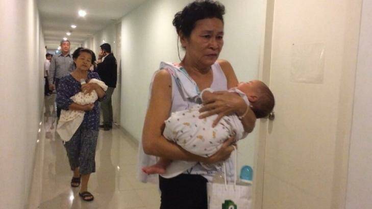 Two of the babies found with surrogate mothers in a Bangkok condominium.  Photo: Thai Rath TV