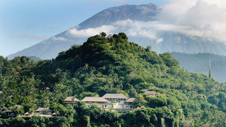 The resort of Amankila is carved into the hillside with cloud-swathed Mount Agung in the distance. 