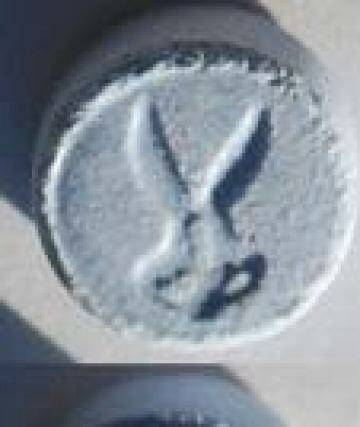 An "ecstasy" pill, with scissor stamp, similar to the one used by the four people hospitalised . Photo: NSW Police