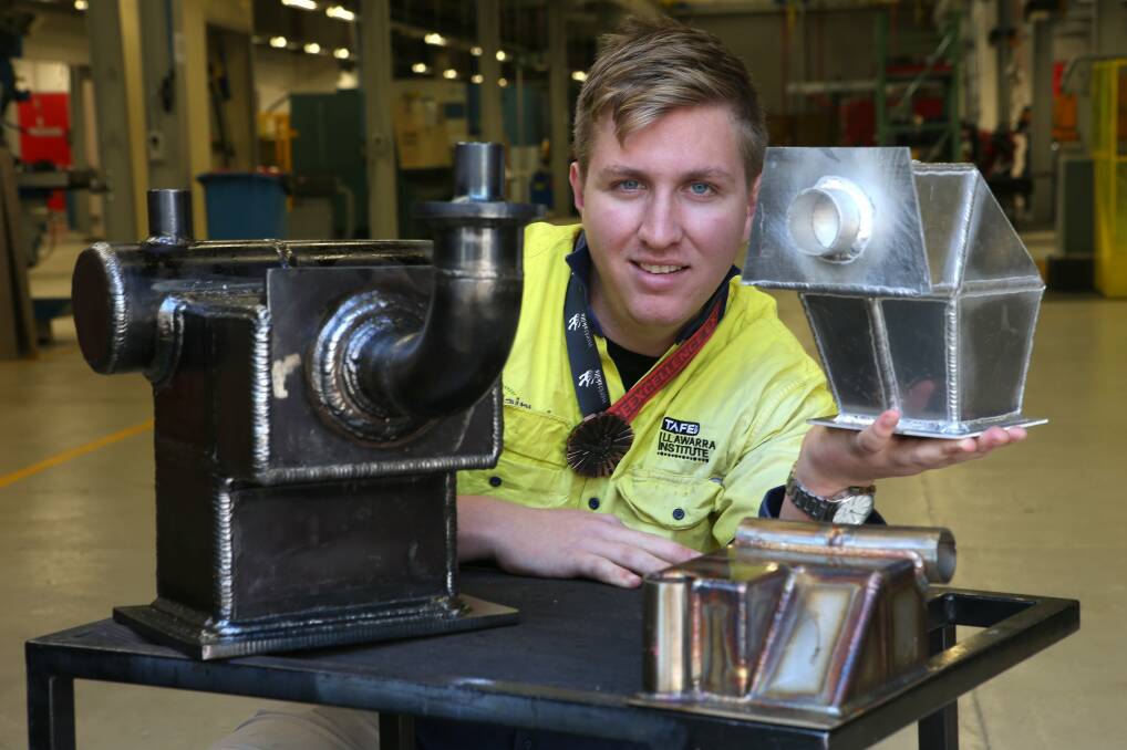 TAFE Illawarra graduate Kallon McVicar with the items he welded in Brazil to win a medal at WorldSkills International. Picture: KIRK GILMOUR