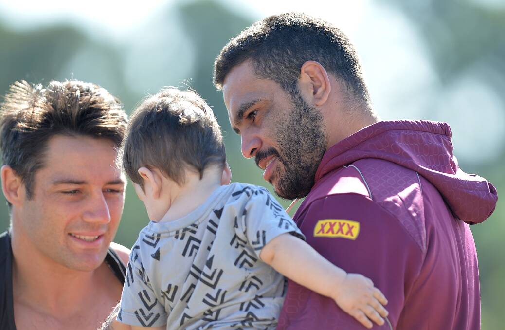 Greg Inglis making friends at Queensland training in Brisbane on Sunday before leaving for Sydney with his teammates for the State of Origin series opener against NSW on Wednesday night. Picture: GETTY IMAGES
