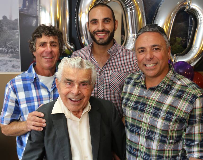 Happy 100: Victor Joukador, Omar Nemer and George Joukador help Ramez Joukador celebrate his 100th birthday at Samaras Woonona. The two families are old friends. Picture: GREG ELLIS