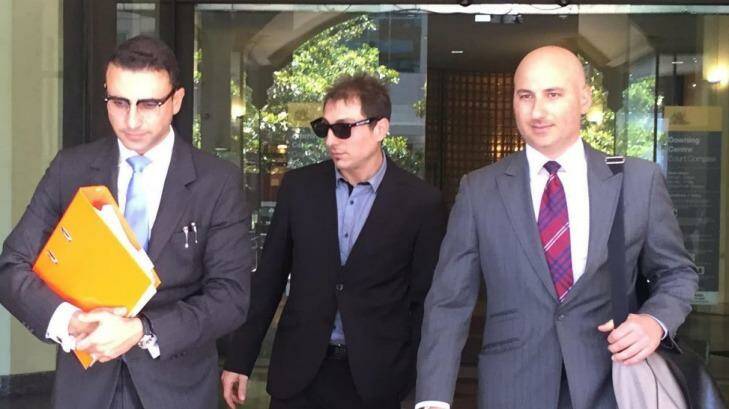 Giovanni? Mancuso (centre) leaves court after being sentenced.