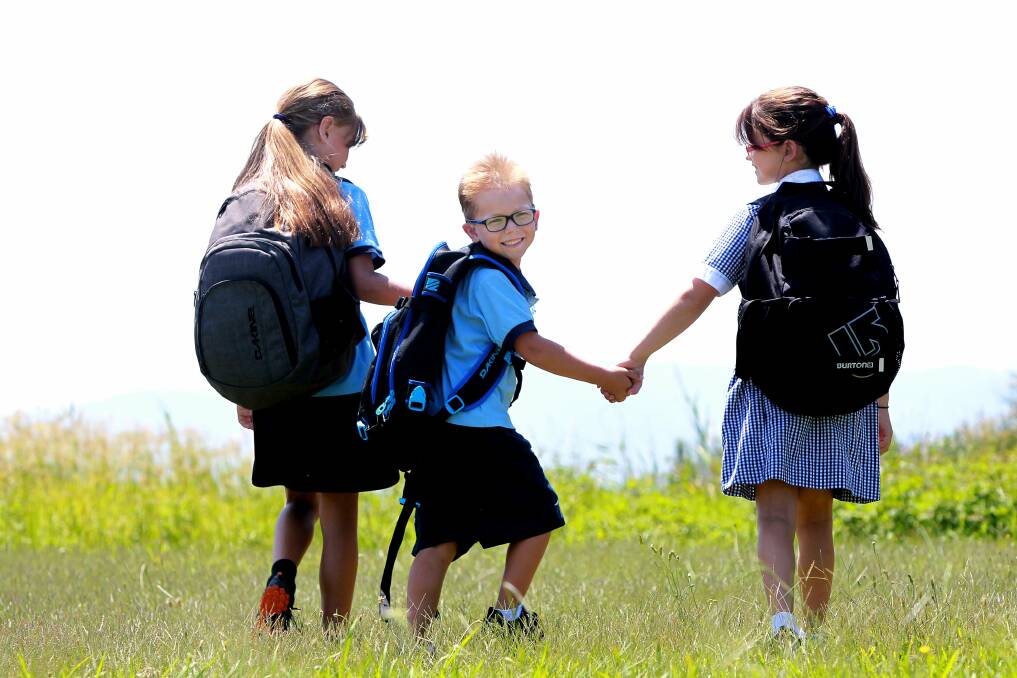 Caleb Best, with his sisters Matilda and Ebony Best, wears his school uniform ahead of his first day at big school. Picture: SYLVIA LIBER