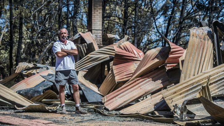 A home belonging to Richard Graham that lost in the Tarago fires. Farm-hand Scott Williams checks the damage. Photo: Karleen Minney