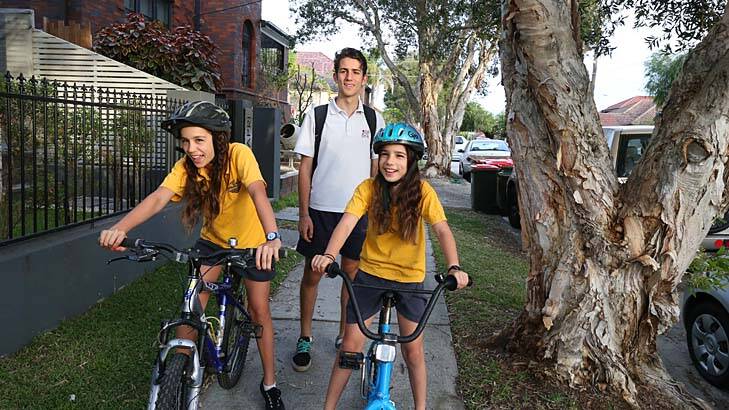 Road to good health: Oliver McCue, 15, walks to school while sisters Mia, 12, and Jenna, 10, cycle from their home in Bondi. Photo: Peter Rae