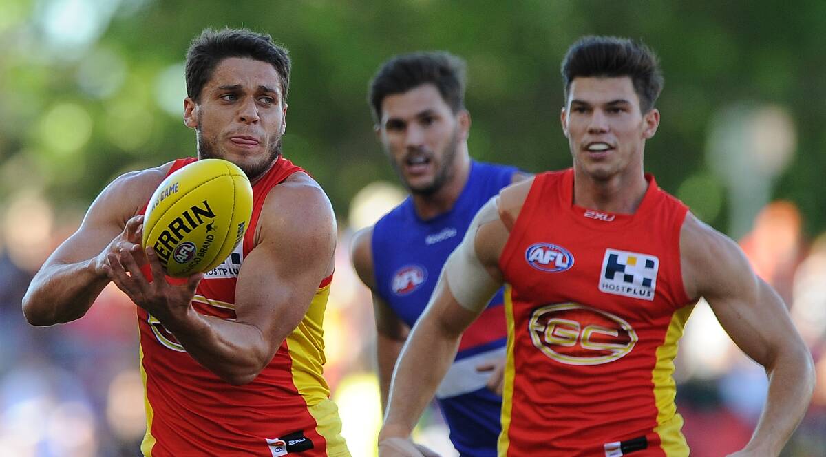 Dion Prestia of the Suns handballs during their round-10 match against the Western Bulldogs. Picture: GETTY IMAGES