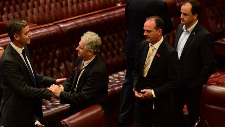 Other members congratulate Mr Graham after his speech, which called for policy changes in NSW. Photo: Wolter Peeters