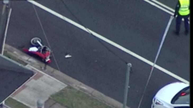 A damaged trail bike is left on the side of the road after an accident and police pursuit. Photo: Nine News