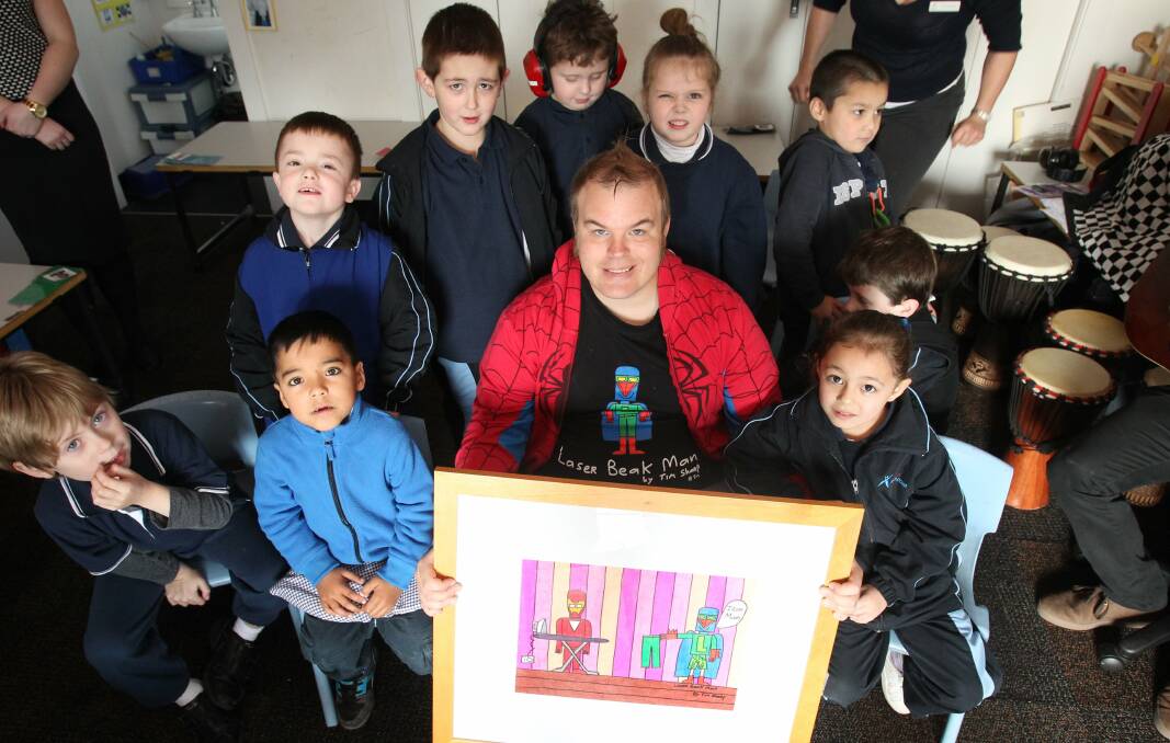 Artist Tim Sharp shares his creation, Laser Beak Man, with children ahead of the Aspect South Coast School's Artists with Autism exhibition at North Wollongong this weekend. Picture: GREG TOTMAN