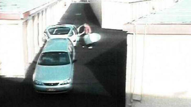CCTV footage of the silver surfboard bag being taken out of the Ford. Photo: Supplied