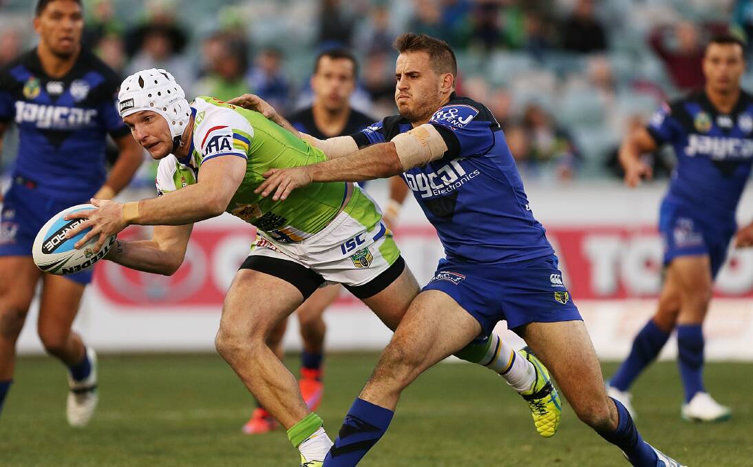 The Raiders' Jarrod Croker tries to escape the clutches of Bulldogs' Josh Reynolds in 13-try thriller in Canberra. Picture: GETTY IMAGES