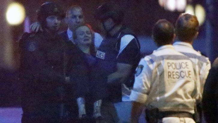 Police rescue Marcia Mikhael from the hostage scene.  Photo: Jason Reed