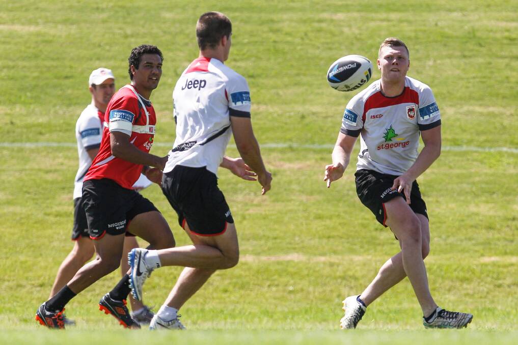 Drew Hutchison throws a pass to team-mates during a Dragons training session.  CHRISTOPHER CHAN