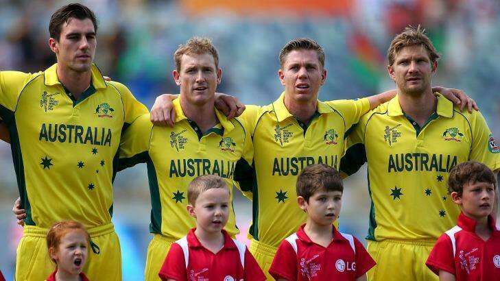 Unusual position: Shane Watson with fellow unused squad members Pat Cummins, George Bailey and Xavier Doherty sing the Australian national anthem before the World Cup match against Afghanistan. Photo: Getty Images 