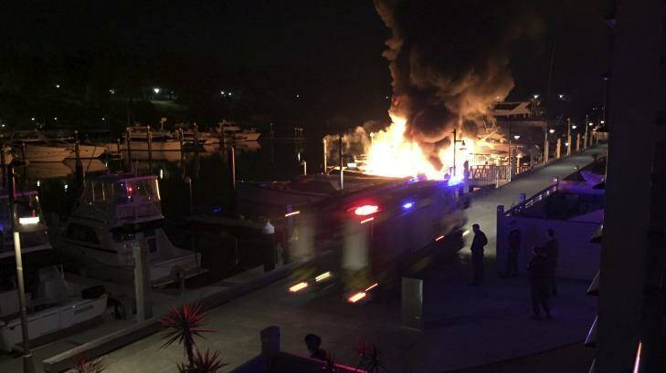 Firefighters at the Finger Wharf in Woolloomooloo at about 4am on Saturday as flames engulf two yachts. Photo: Julian Peterson